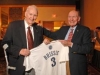 Lou Brissie, left, and former teammate Bill Hockenbury from the 1947 Savannah Indians baseball team hold a commemorative jersey at a banquet at the Riverfront Marriott held for the WWII veteran and former major league pitcher. (John Carrington/Savannah Morning News)
